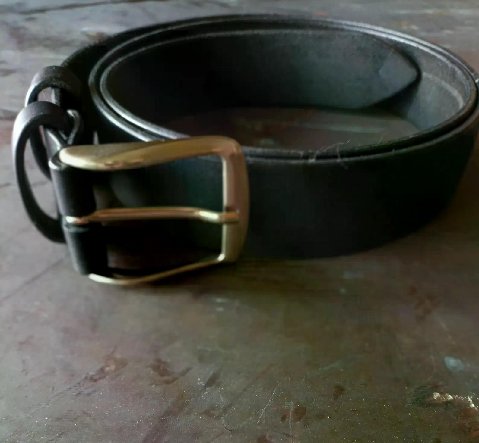 Black full grain leather belt with a classic rectangular metal buckle