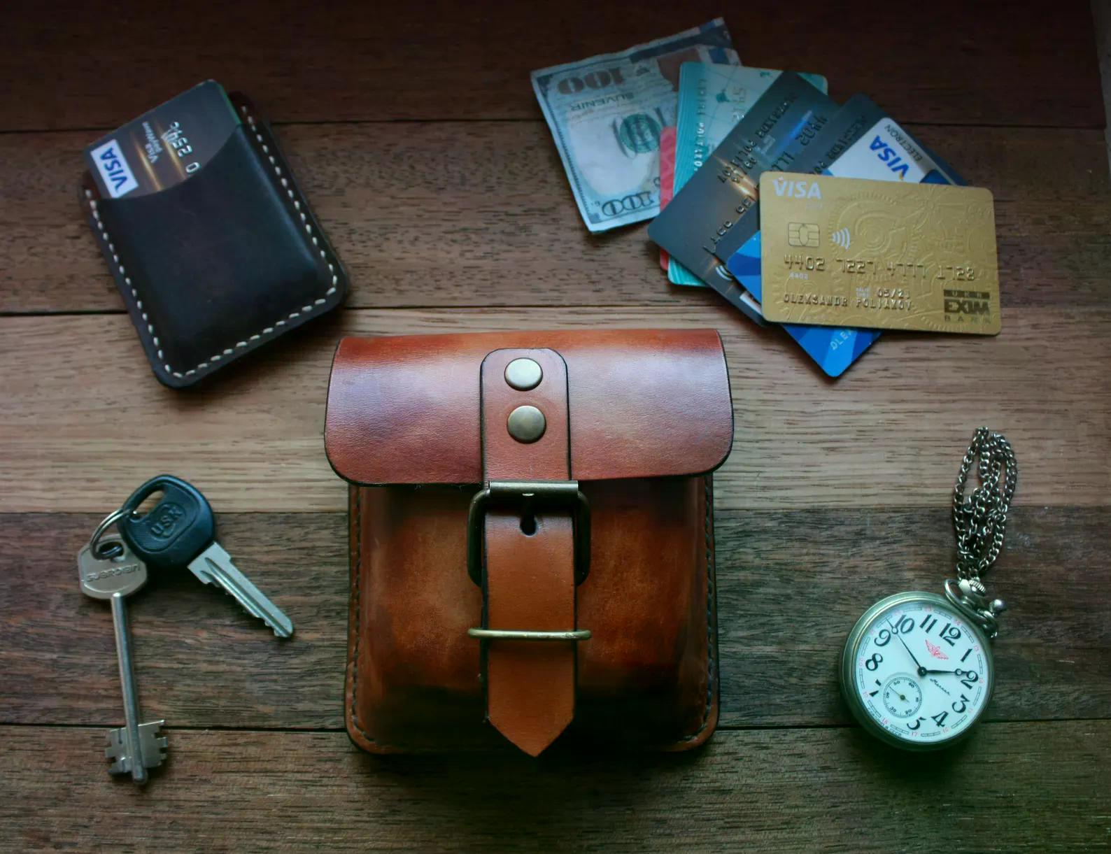 Handmade brown leather EDC pouch displayed with keys, cards and everyday carry accessories