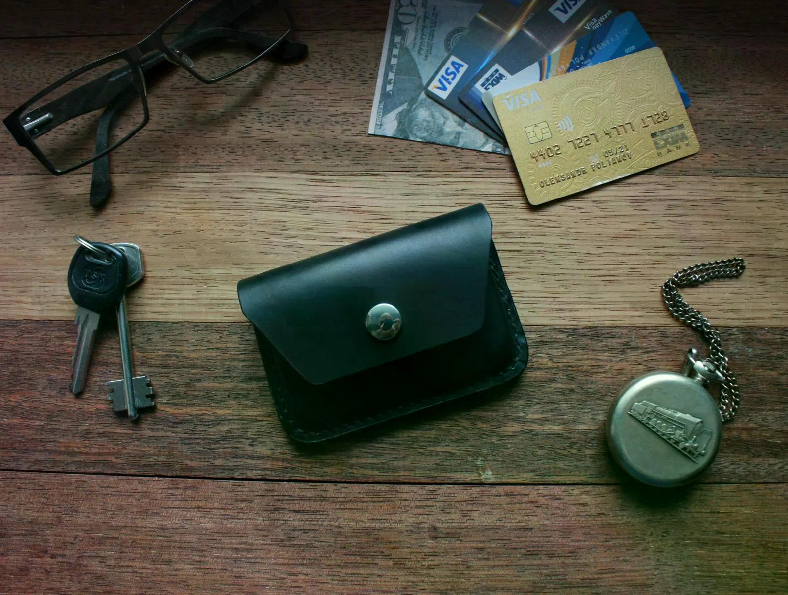 Handmade black leather belt pouch displayed with keys, cards and everyday carry items