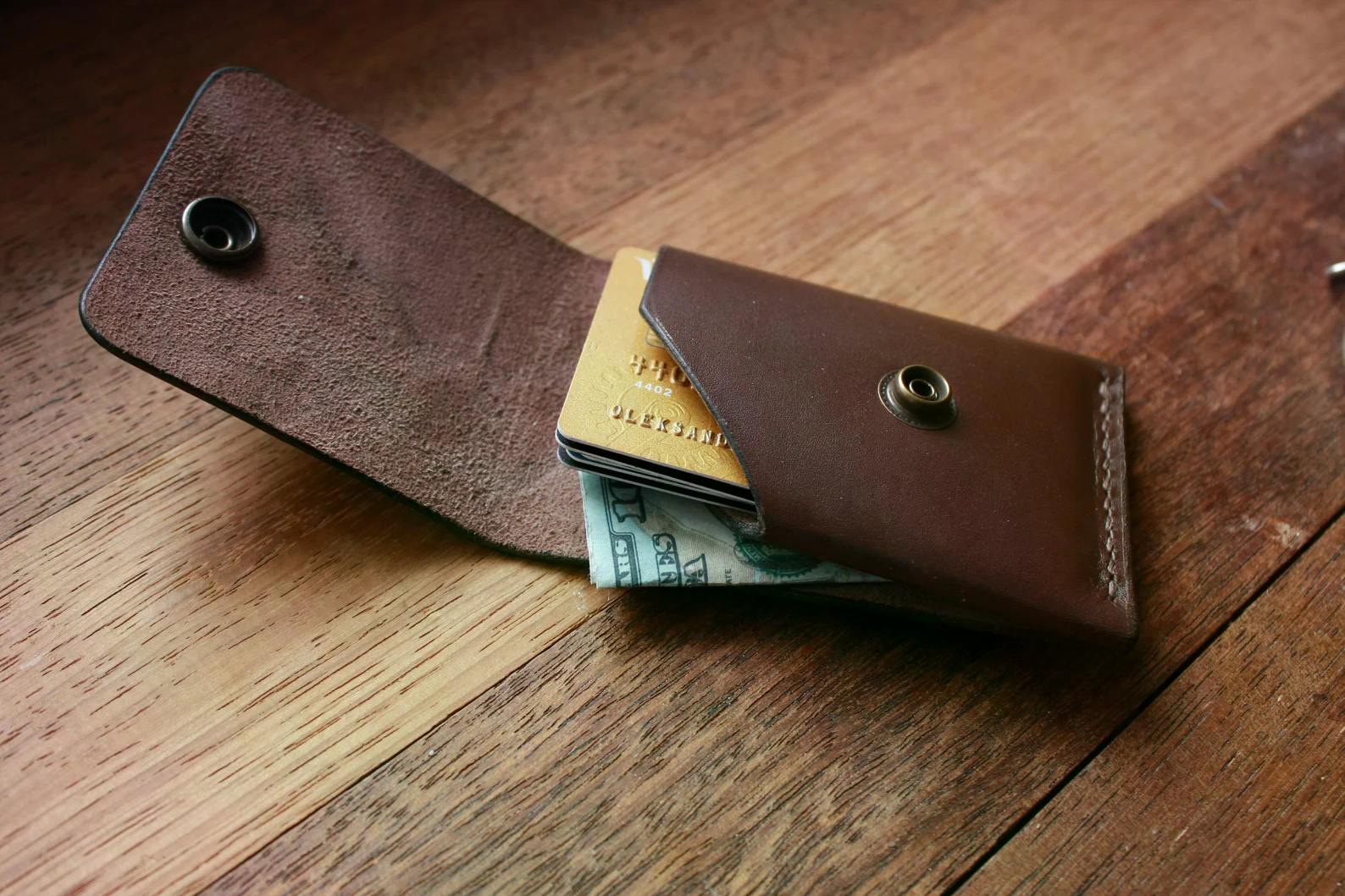Handmade brown leather minimalist wallet and card holder displayed with cards